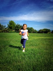 Cute little girl running at the park