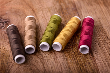 Fototapeta na wymiar cotton sewing autumn color on wood