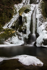 Forest waterfall in winter