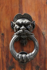Dark wooden door with black dusty handle
