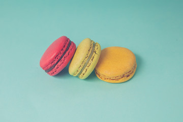 Set of colorful macaroons stacked on each other in blue turquoise pastel isolated background - in vintage tone