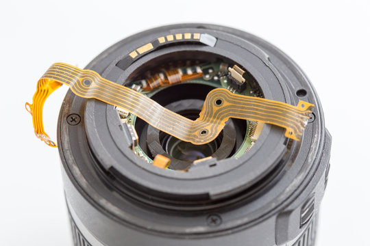 Lens and flat ribbon cable on white background