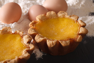 Traditional Egg Tart and ingredients close-up. horizontal
