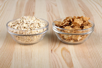 cereals and oatmeal in a bowl on wooden background