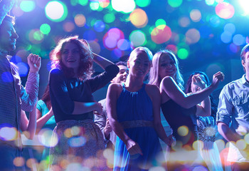 group of happy friends dancing in night club - obrazy, fototapety, plakaty