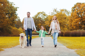 happy family with labrador retriever dog in park