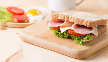 sandwich on wood plate.