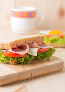 sandwich on wood plate.