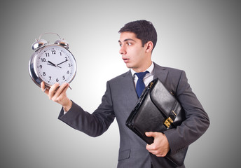 Businessman with clock isolated on white