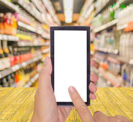 male hand is holding a modern touch screen phone and blurred ima