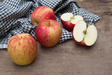 Still life with Red Apples and cloth on a wooden floor.