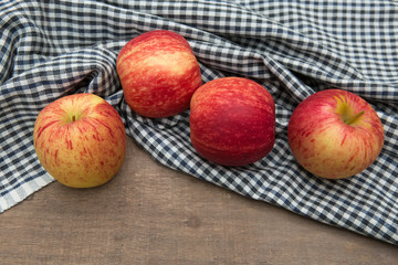 Still life with Red Apples and cloth on a wooden floor.