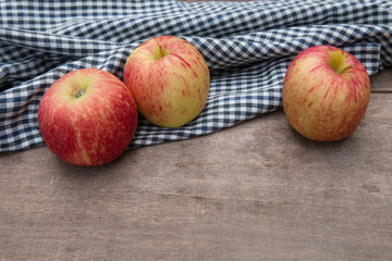 Still life with Red Apples and cloth on a wooden floor.