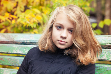 Naklejka premium Caucasian blond teenage girl in black jacket