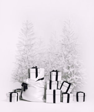 Christmas trees with bag and heap of gift boxes. Black and white