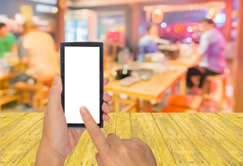 male hand is holding a modern touch screen phone and blur image