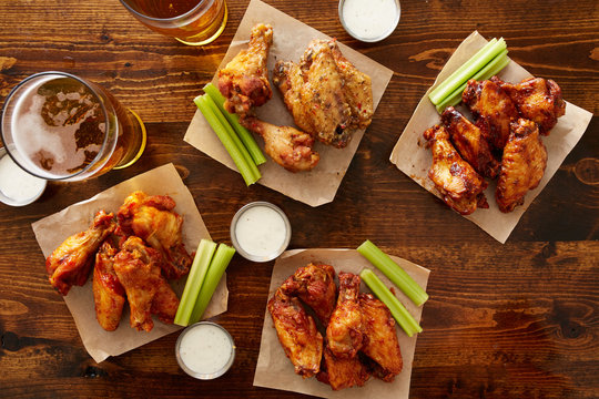 many different flavored buffalo chicken wings with beer party sampler sharing platter shot from top down view