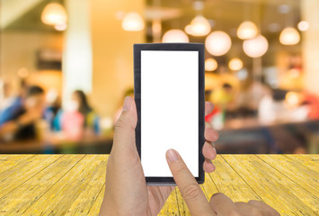 male hand is holding a modern touch screen phone and Coffee shop