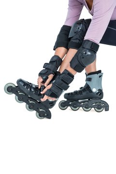 Low section of sporty woman wearing inline skates