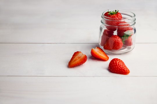 Fresh strawberries in glass jar