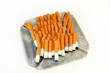 Pile of the cigarette butts in the ashtray