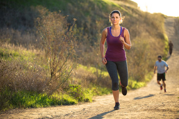 Fototapeta na wymiar Woman jogging path running determined inspired motivated leading race