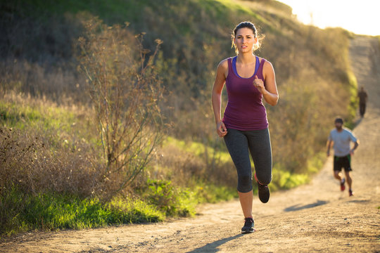 Woman jogging path running determined inspired motivated leading race