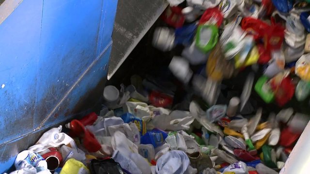 Close up of recyclables on a cleated conveyor