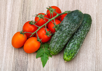 Cucumbers and tomatoes on the branch