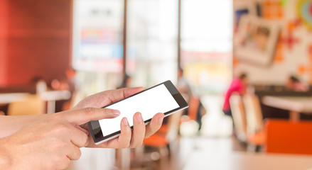 male hand is holding a modern touch screen phone and Coffee shop