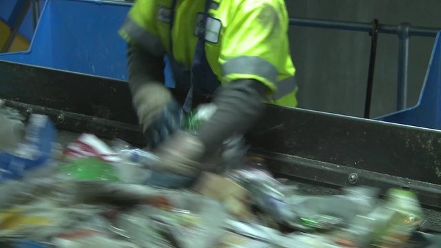 Trash workers weeding through recyclables