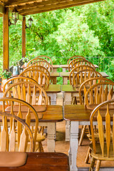 Row of retro wooden tables and chairs in a restaurant