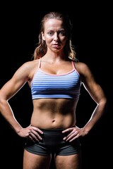 Fototapeta premium Portrait of female athlete with hands on hip