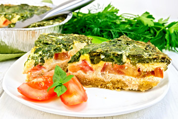 Pie celtic with spinach and tomato in plate on table