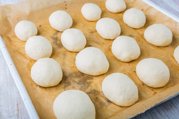 Fototapeta na wymiar Hand made bread dough cut and formed into bread rolls