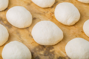 Hand made bread dough cut and formed into bread rolls