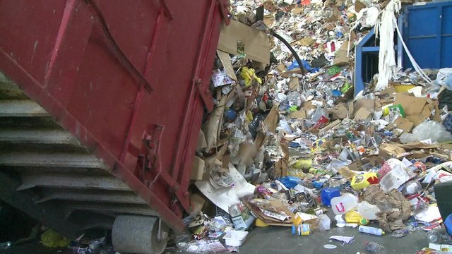 Dump trucks dumping waste