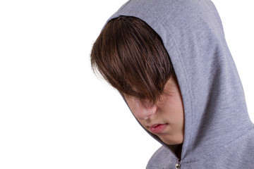 Young man portrait in hooded sweatshirt / jumper being photographed in a studio. Isolated on white background