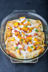 Pancakes with cottage cheese and peach doused sour cream