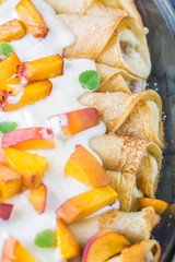Pancakes with cottage cheese and peach doused sour cream