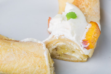 Pancak with cottage cheese and peach doused sour cream