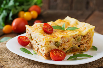 Lasagna with minced meat, green peas and sauce