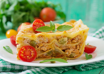 Lasagna with minced meat, green peas and sauce