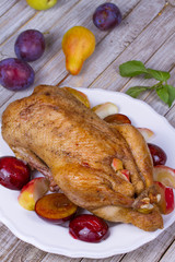 Roast duck with plums and apples