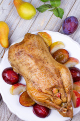 Roast duck with plums and apples
