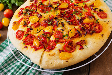 Italian focaccia with tomatoes, peppers and onions.