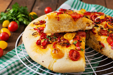 Italian focaccia with tomatoes, peppers and onions.