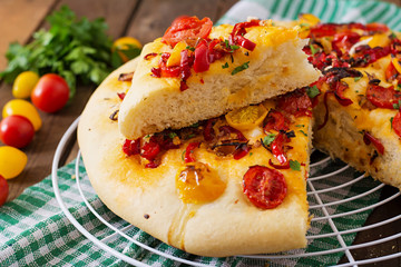 Italian focaccia with tomatoes, peppers and onions.