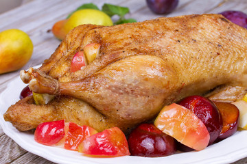 Roast duck with plums and apples