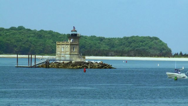 Small lighthouse in the middle of a harbor